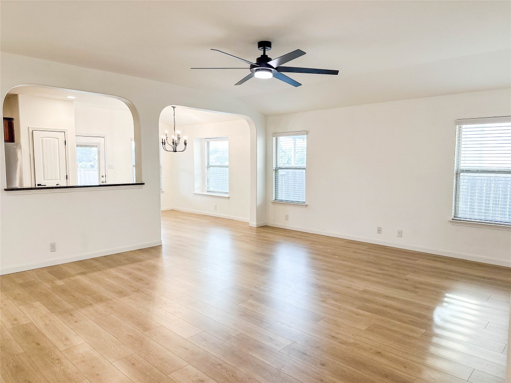 1437 April Meadows Loop Georgetown, TX 78626 - Photo 6 of 27 a view of a livingroom with wooden floor and a ceiling fan
