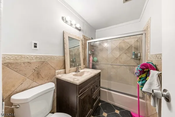 a bathroom with a sink mirror vanity and toilet