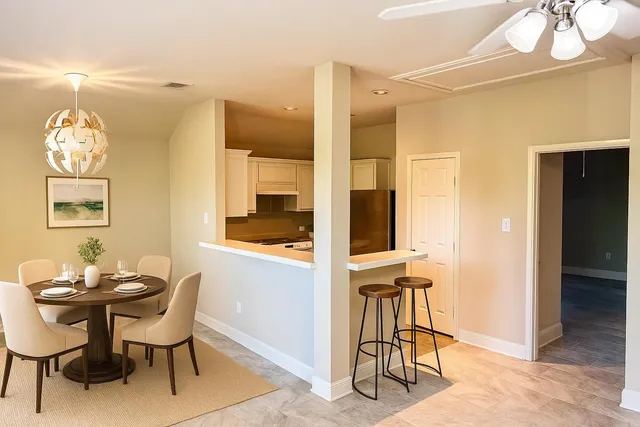 a dining room with furniture and window