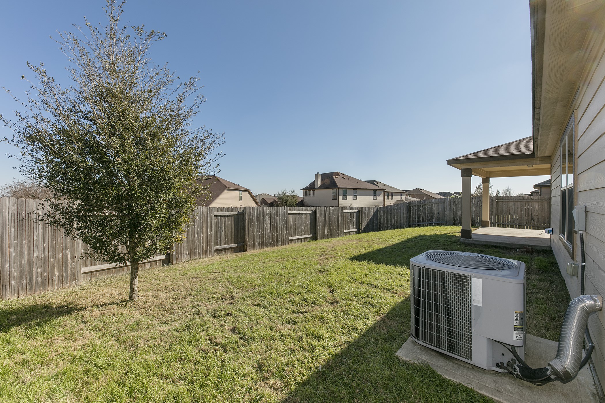 1141 Renaissance Trail Round Rock, TX 78665 - Photo 18 of 23 A fenced backyard with a tree and a covered patio offers ample outdoor living space.