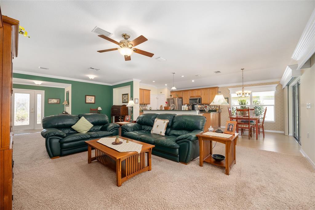 12309 Southeast 92nd Court Road Summerfield, FL 34491 - Photo 13 of 81 a living room with furniture ceiling fan and a rug