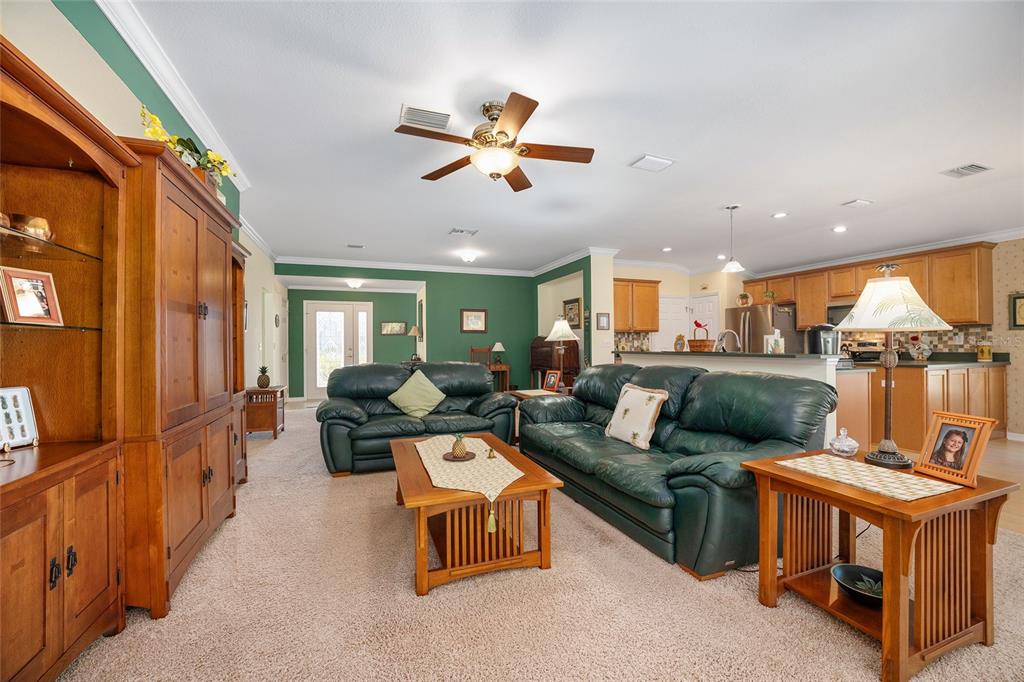 12309 Southeast 92nd Court Road Summerfield, FL 34491 - Photo 14 of 81 a living room with furniture ceiling fan and a rug
