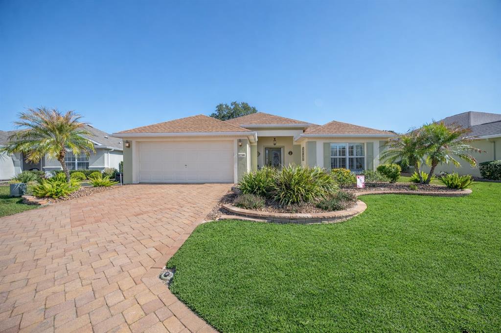 12309 Southeast 92nd Court Road Summerfield, FL 34491 - Photo 2 of 81 a front view of a house with a yard and porch