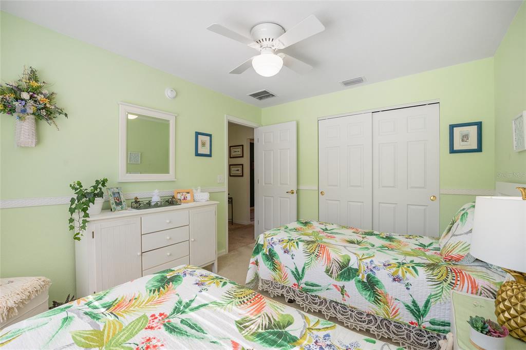12309 Southeast 92nd Court Road Summerfield, FL 34491 - Photo 30 of 81 a bedroom with a bed and a chandelier