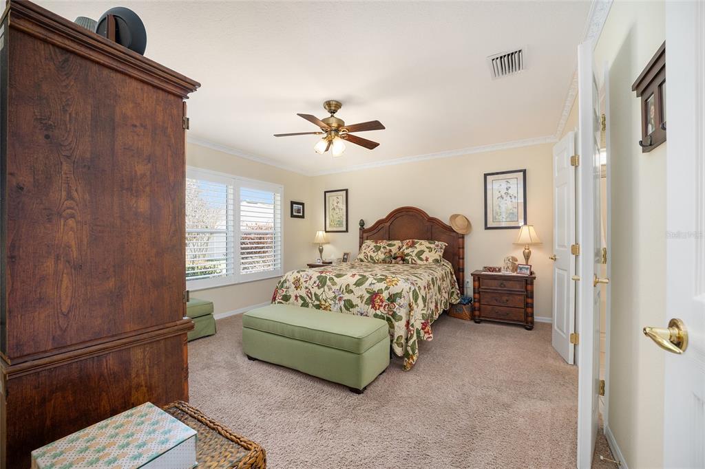 12309 Southeast 92nd Court Road Summerfield, FL 34491 - Photo 36 of 81 a bedroom with a bed and a ceiling fan
