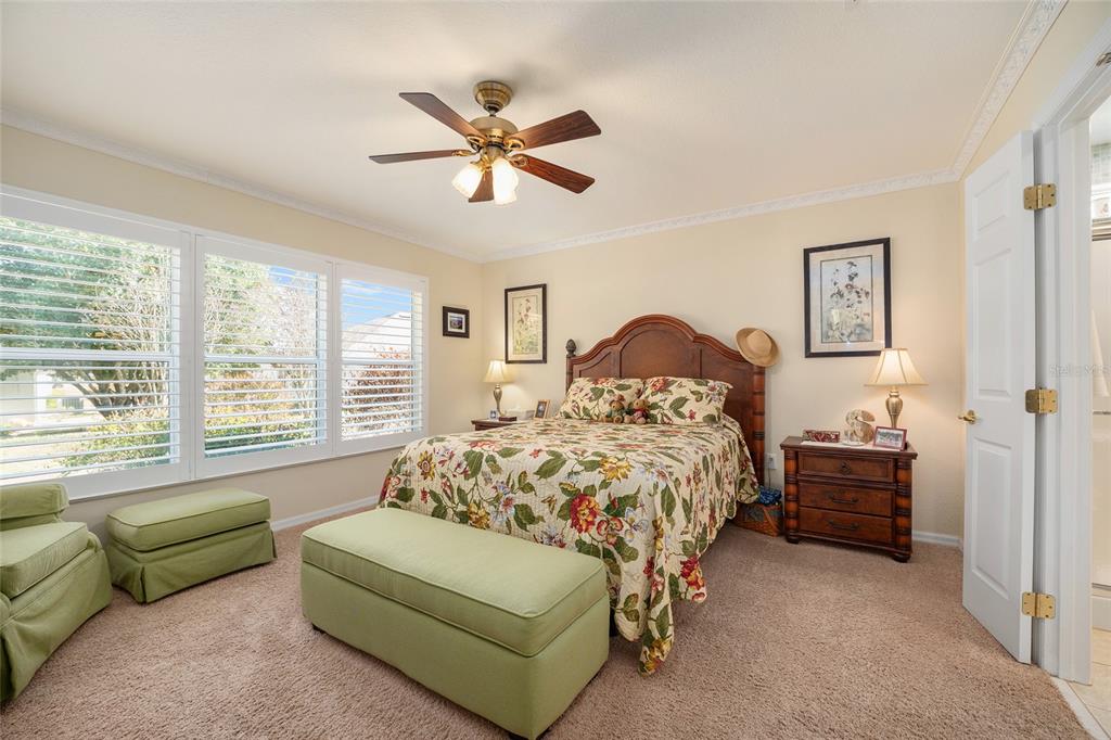 12309 Southeast 92nd Court Road Summerfield, FL 34491 - Photo 37 of 81 a bedroom with a bed a couch and a window