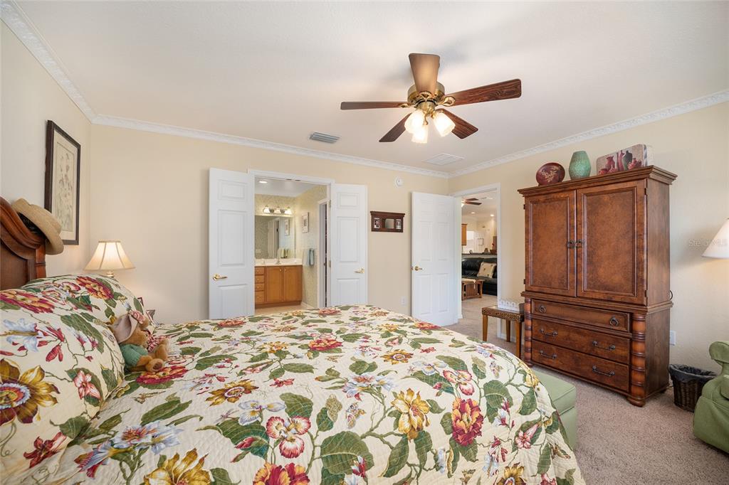 12309 Southeast 92nd Court Road Summerfield, FL 34491 - Photo 38 of 81 a bedroom with a bed and a dresser