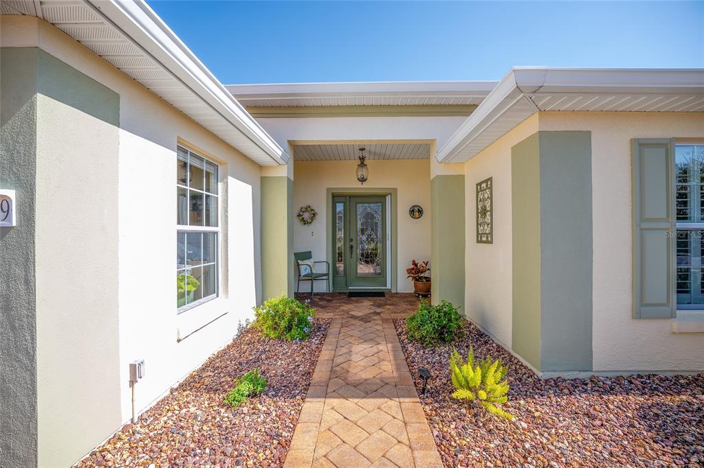 12309 Southeast 92nd Court Road Summerfield, FL 34491 - Photo 4 of 81 a view of a entryway door front of house
