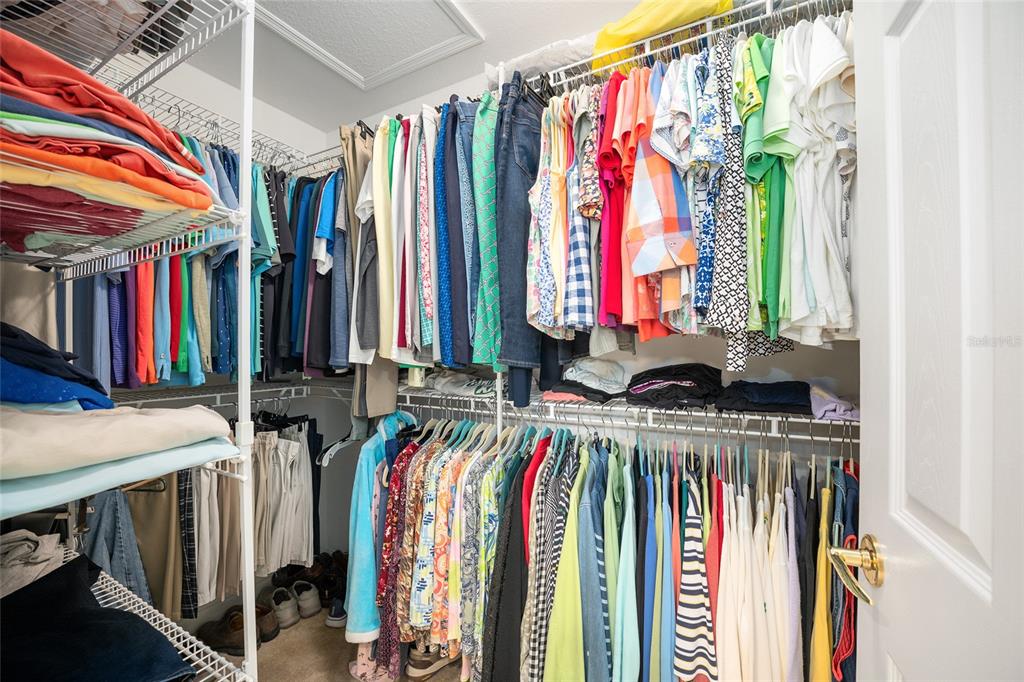 12309 Southeast 92nd Court Road Summerfield, FL 34491 - Photo 43 of 81 a view of walk in closet with clothes and shoes