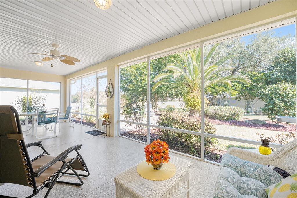 12309 Southeast 92nd Court Road Summerfield, FL 34491 - Photo 46 of 81 a living room with patio furniture and a floor to ceiling window