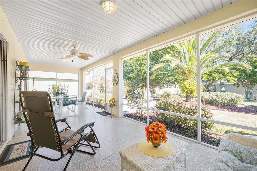 12309 Southeast 92nd Court Road Summerfield, FL 34491 - Photo 47 of 81 a living room with furniture and a floor to ceiling window