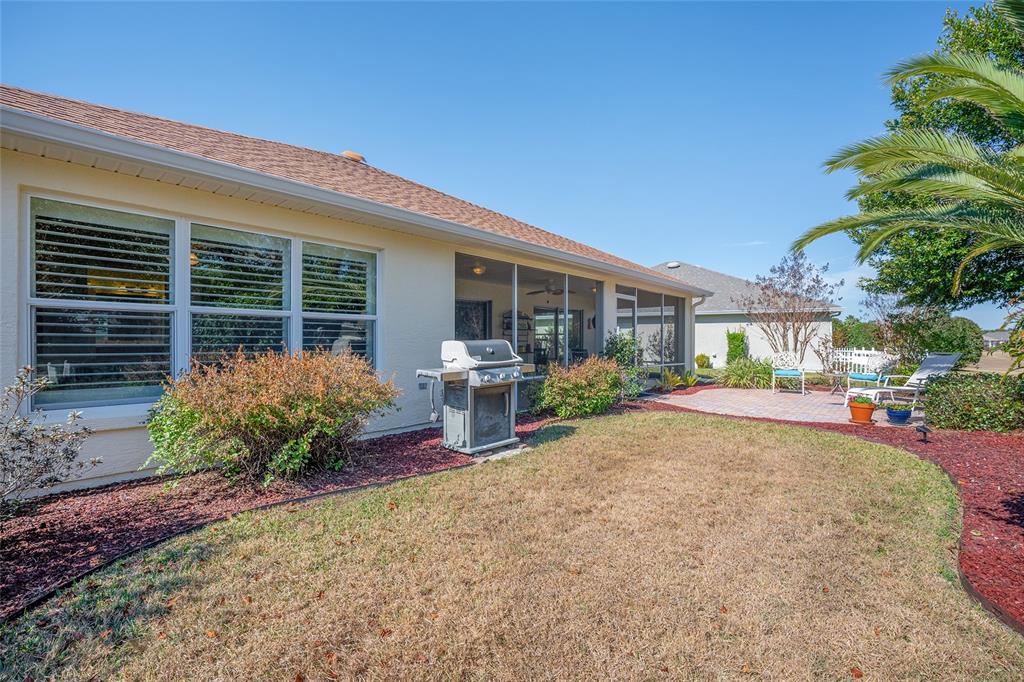 12309 Southeast 92nd Court Road Summerfield, FL 34491 - Photo 60 of 81 a front view of a house with garden and plants