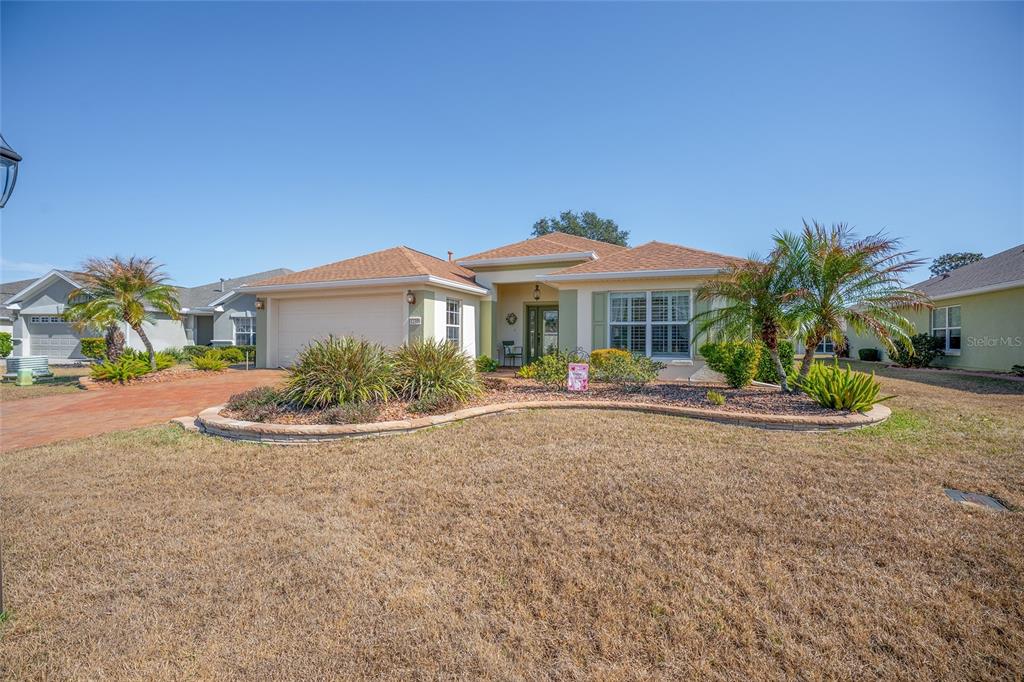 12309 Southeast 92nd Court Road Summerfield, FL 34491 - Photo 61 of 81 a view of a house with a yard and potted plants