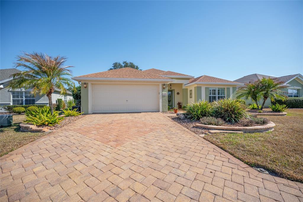 12309 Southeast 92nd Court Road Summerfield, FL 34491 - Photo 63 of 81 a front view of a house with a yard and garage