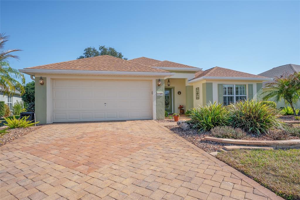 12309 Southeast 92nd Court Road Summerfield, FL 34491 - Photo 64 of 81 a front view of a house with a yard