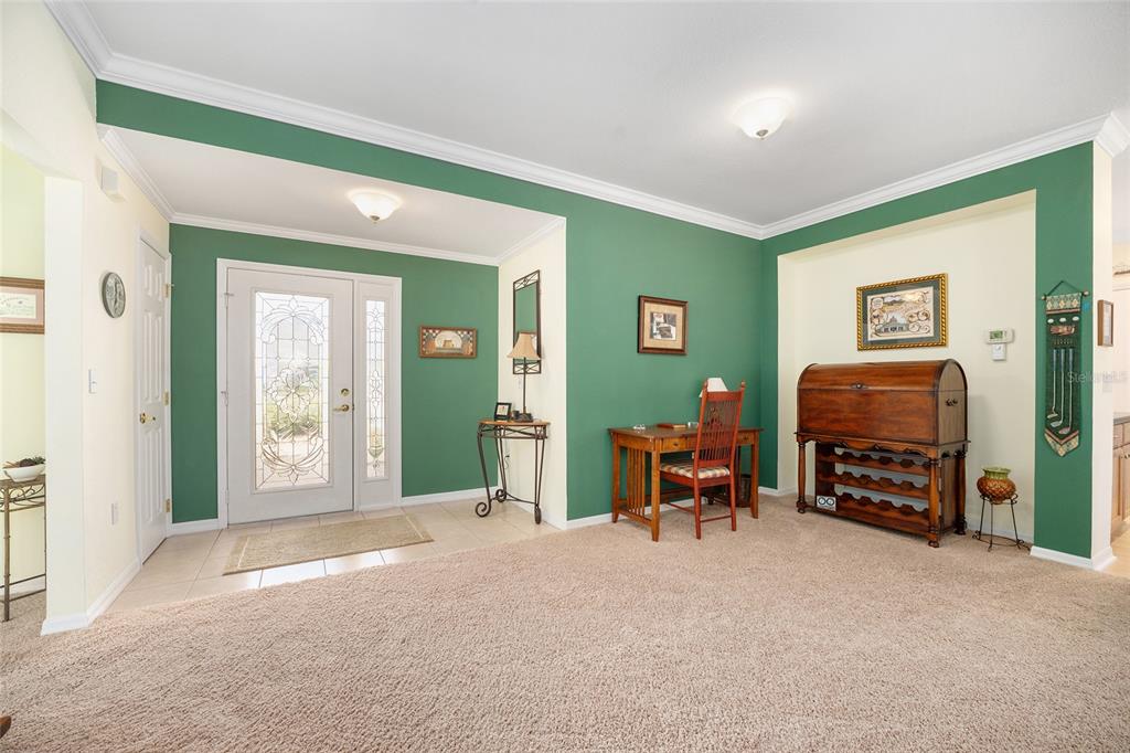 12309 Southeast 92nd Court Road Summerfield, FL 34491 - Photo 9 of 81 a living room with furniture a fireplace and a large window