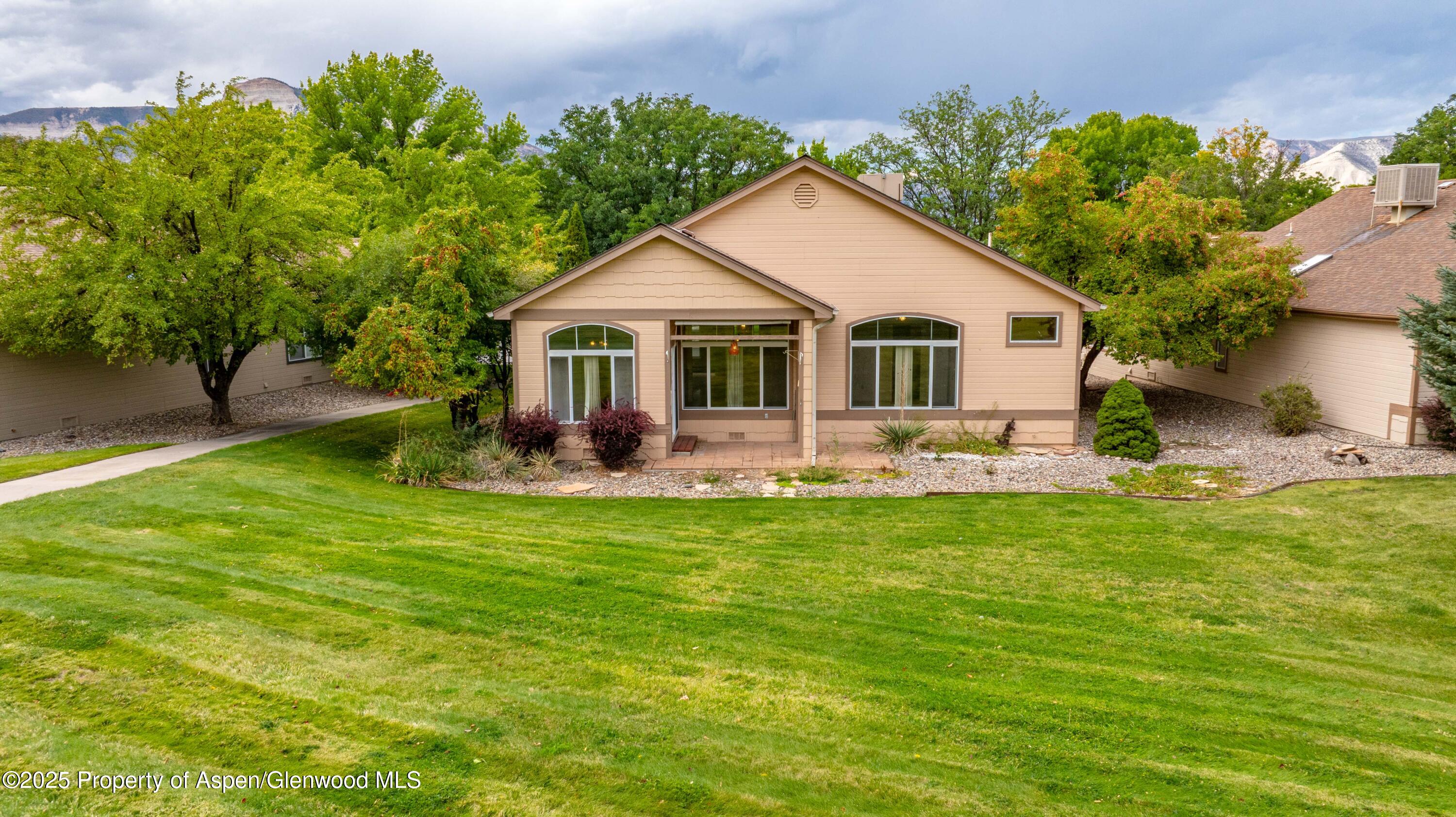 62 Limberpine Circle Parachute, CO 81635 - Photo 2 of 26 a view of a house with a yard and a garden