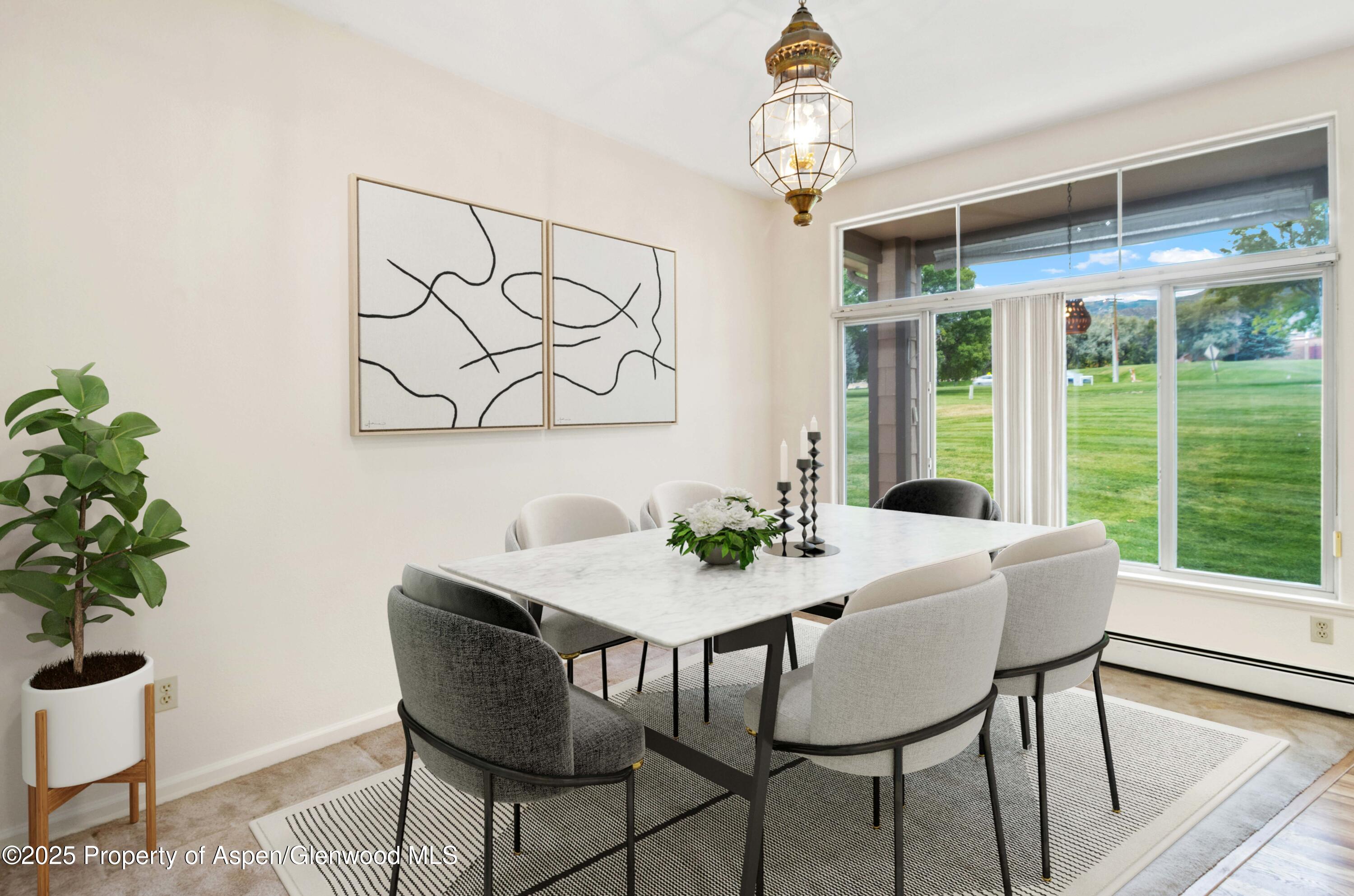 62 Limberpine Circle Parachute, CO 81635 - Photo 6 of 26 a view of a dining room with furniture window and wooden floor