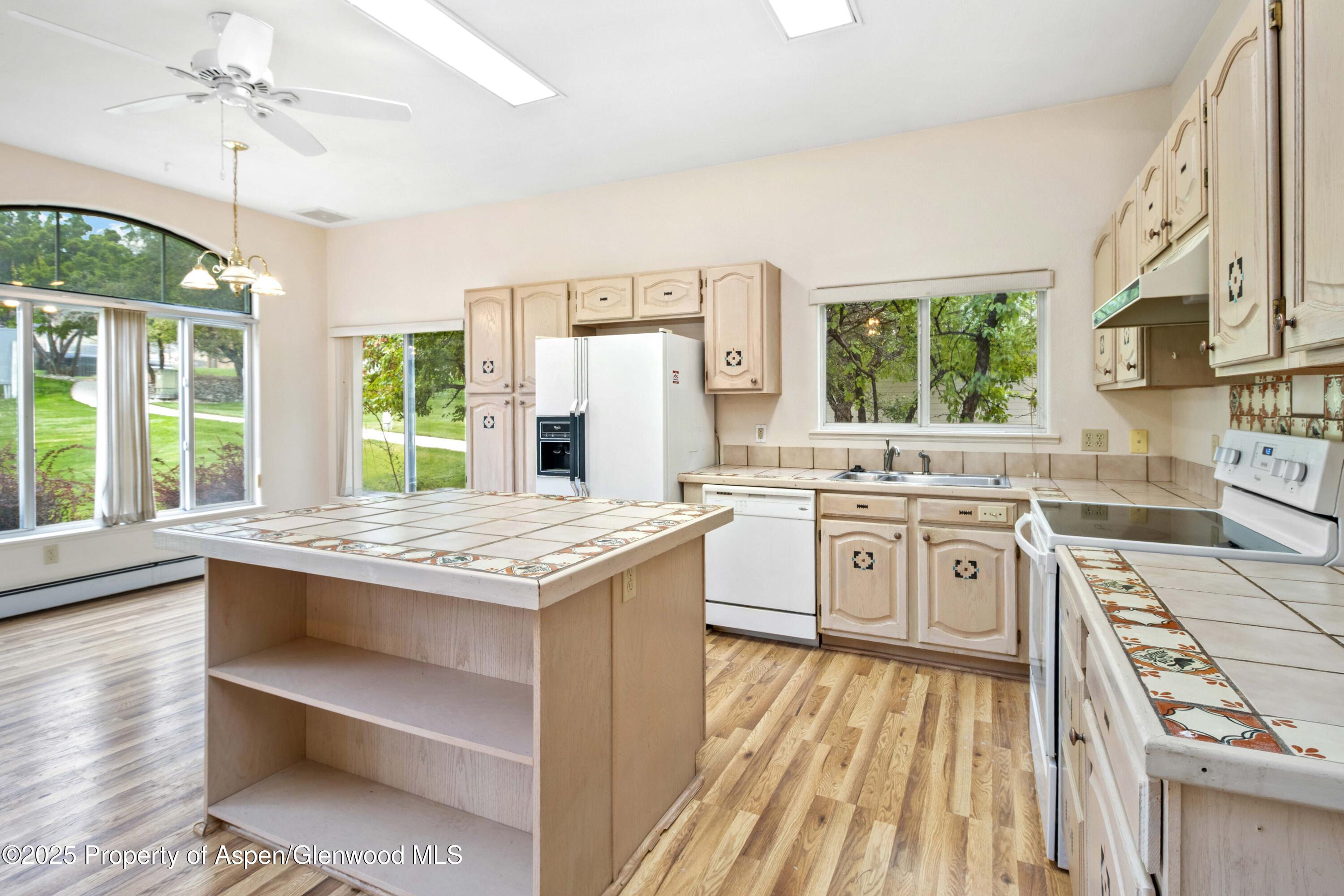 62 Limberpine Circle Parachute, CO 81635 - Photo 7 of 26 a kitchen with granite countertop a sink appliances cabinets and a counter top space