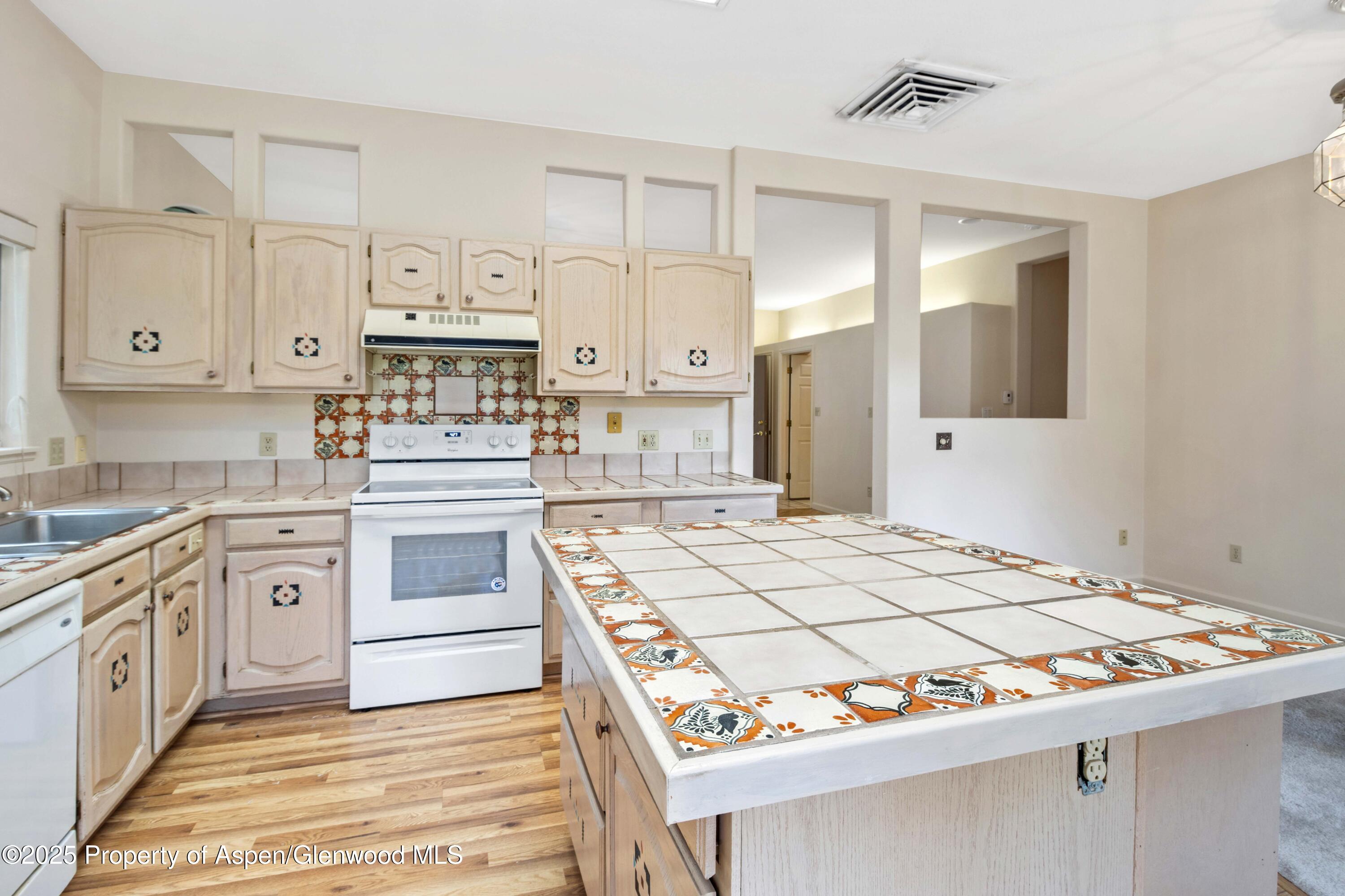 62 Limberpine Circle Parachute, CO 81635 - Photo 8 of 26 a kitchen with stainless steel appliances granite countertop a stove and white cabinets