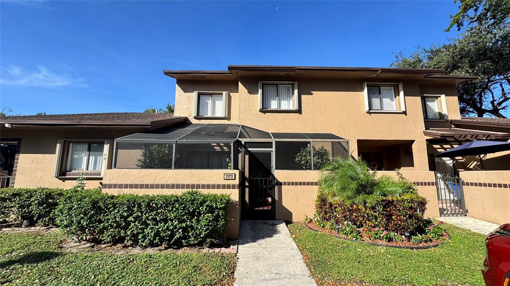a front view of a house with a garden