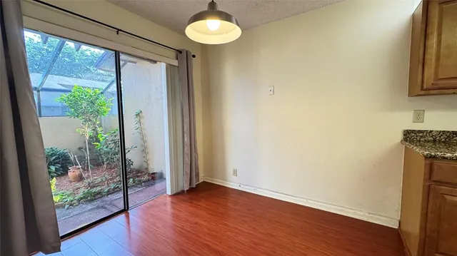 a view of a room with wooden floor and front door