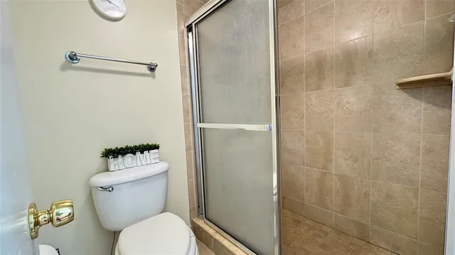 a white toilet sitting next to a bathroom sink