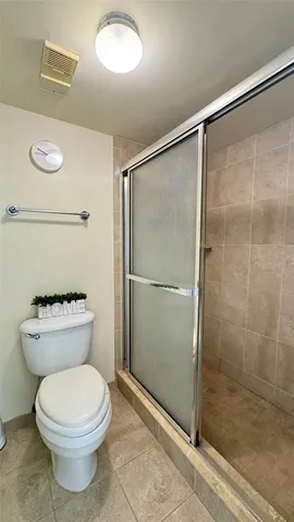 a bathroom with a toilet and a shower