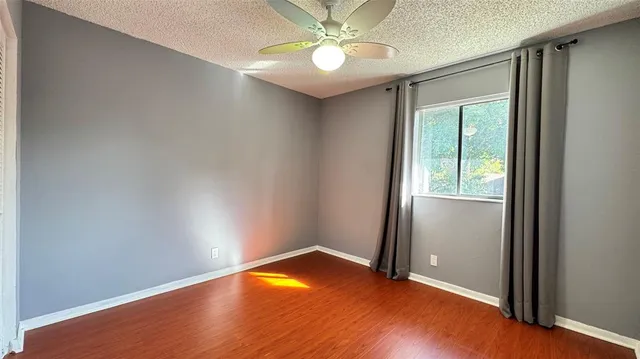 an empty room with a window and closet