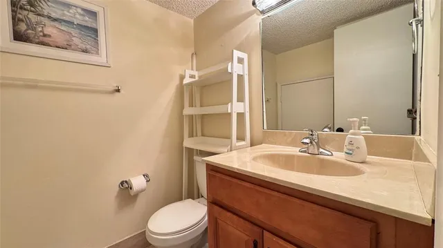 a bathroom with a sink toilet and mirror