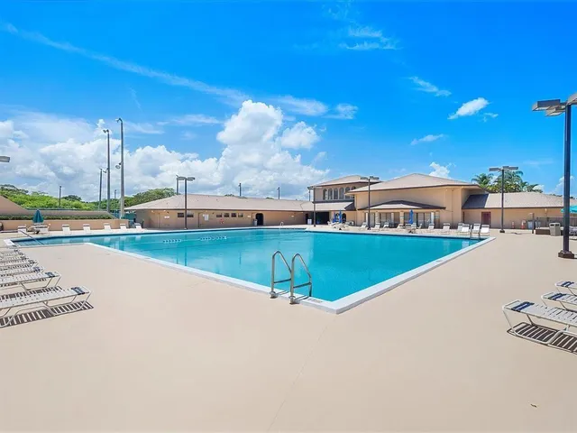 a swimming pool with outdoor seating and yard