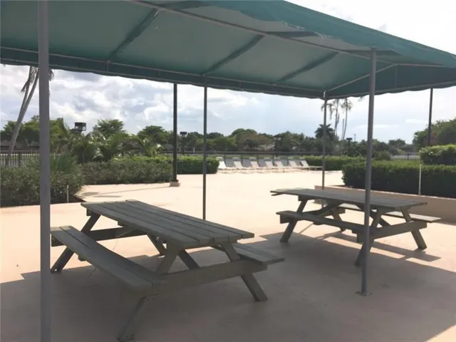 a view of a lake with couches in patio
