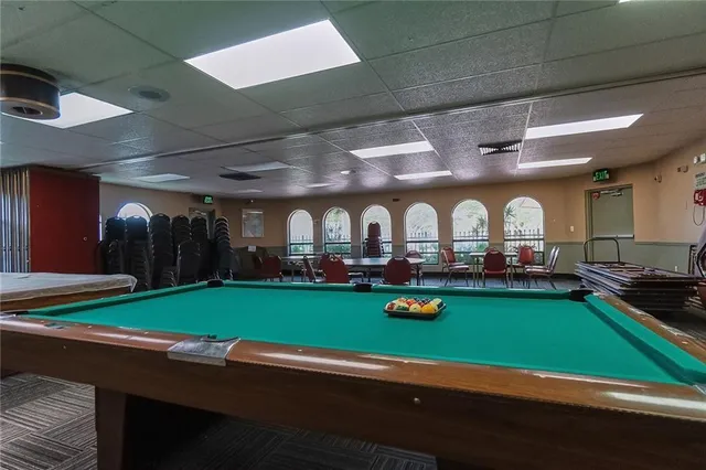 a room with lots of trees and outdoor seating