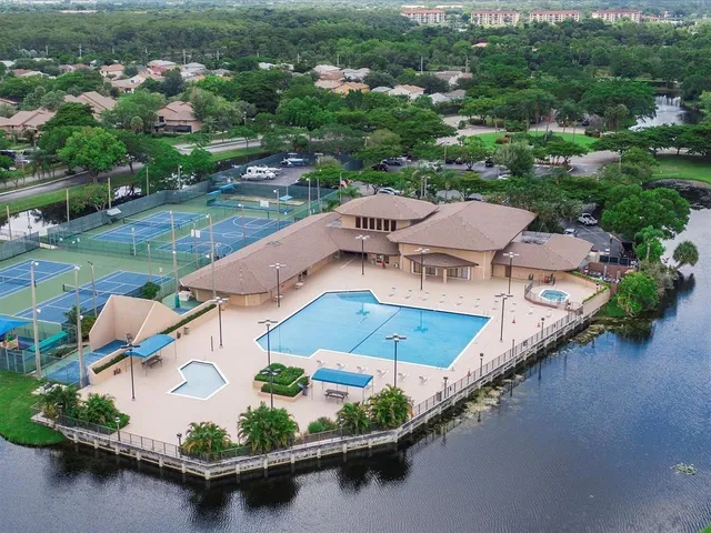 an aerial view of residential houses with outdoor space and river