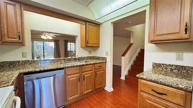 a kitchen with granite countertop a stove and a sink