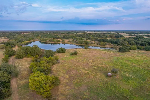 an aerial view of a house with a yard
