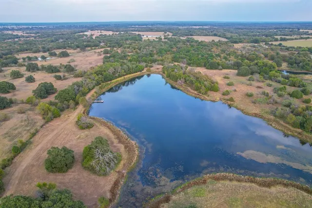 a view of a lake with houses in the back