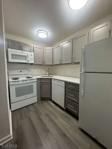 a kitchen with a white cabinets and white appliances