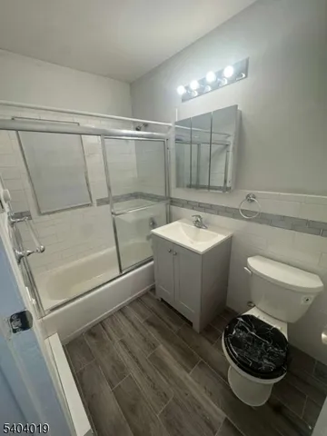 a bathroom with a sink a toilet and bathtub
