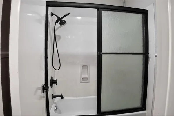 a bathroom with a glass shower door