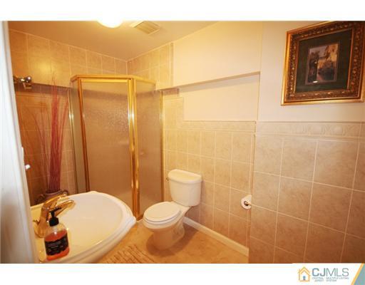 11 Gramercy Road Monmouth Junction, NJ 08852 - Photo 16 of 25 a bathroom with a toilet a sink and shower