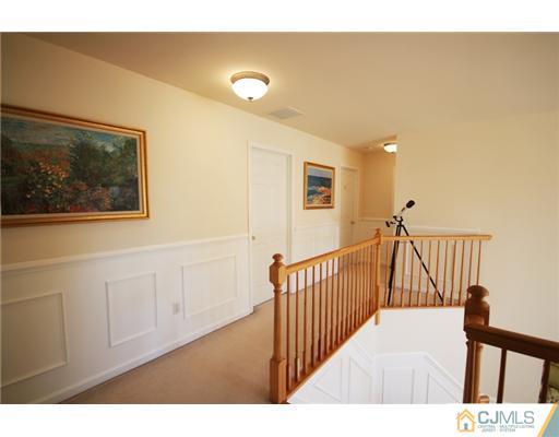 11 Gramercy Road Monmouth Junction, NJ 08852 - Photo 17 of 25 a view of a hallway with wooden floor and windows