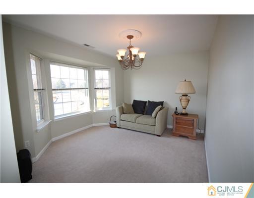 11 Gramercy Road Monmouth Junction, NJ 08852 - Photo 19 of 25 a living room with furniture and a chandelier