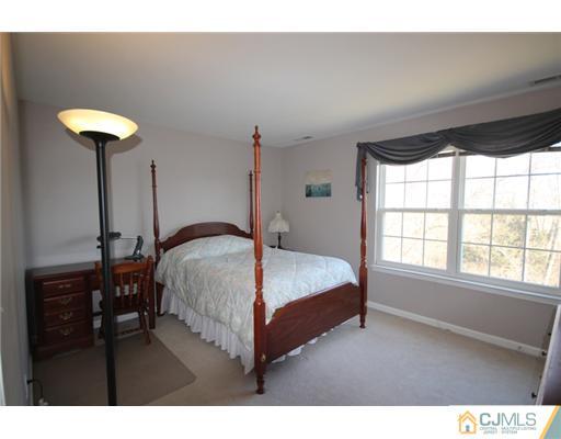 11 Gramercy Road Monmouth Junction, NJ 08852 - Photo 23 of 25 a bed sitting in a bedroom next to a window