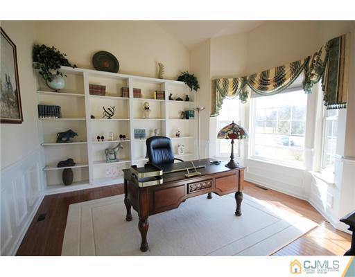 11 Gramercy Road Monmouth Junction, NJ 08852 - Photo 7 of 25 a living room with a black white checkered floor and a large window