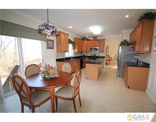 11 Gramercy Road Monmouth Junction, NJ 08852 - Photo 10 of 25 a view of a dining room with furniture a kitchen and chandelier