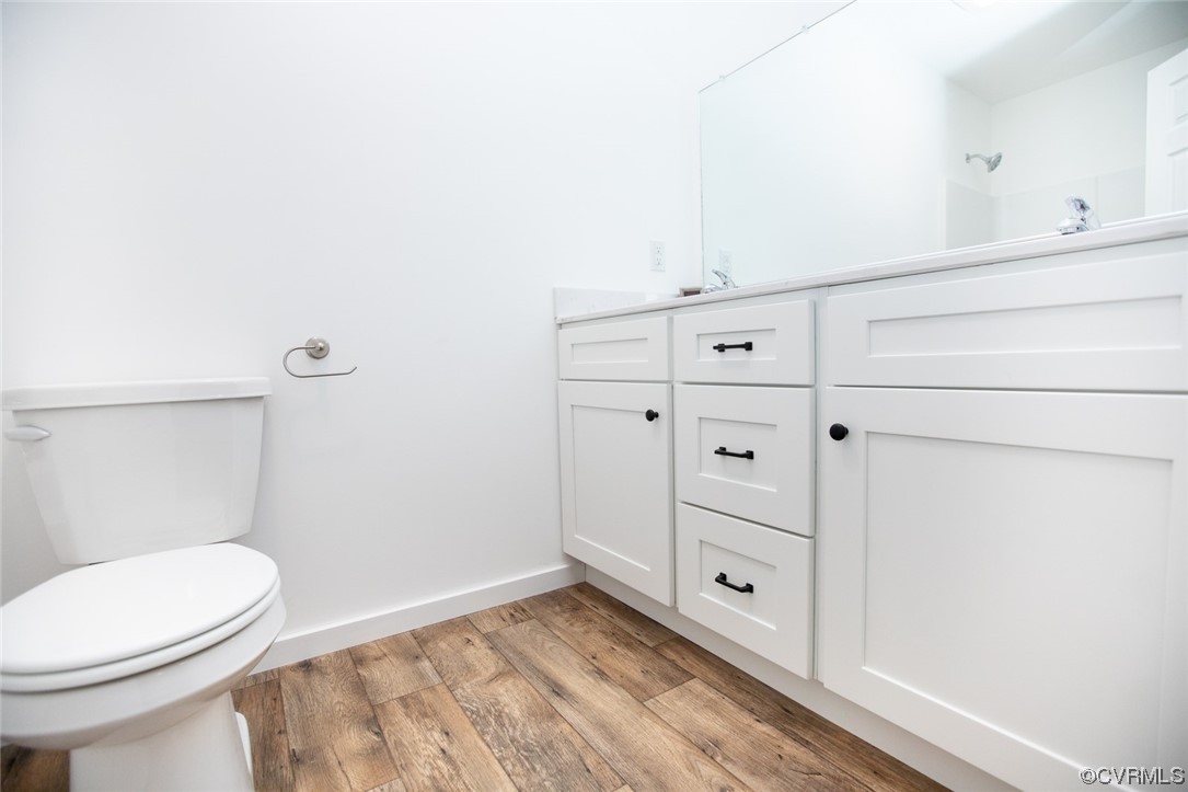 22 Abrams Road Farmville, VA 23901 - Photo 33 of 42 a bathroom with a toilet a sink a vanity and mirror