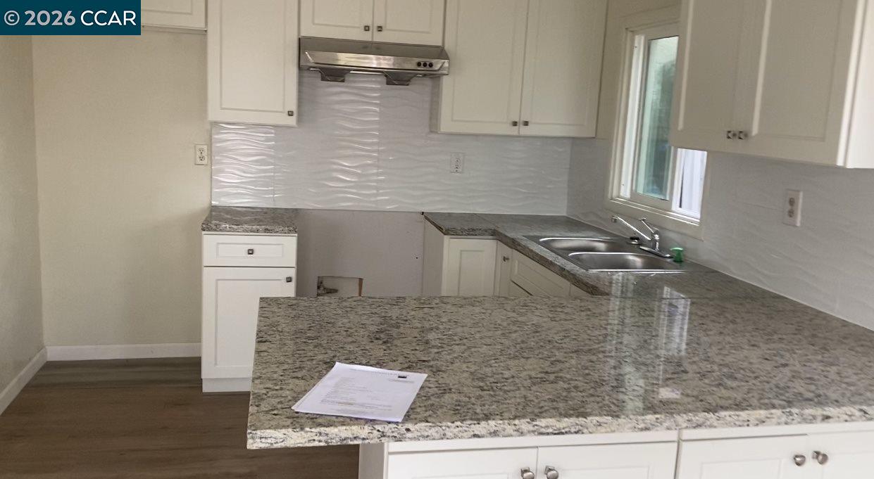 809 West 2nd Street Antioch, CA 94509 - Photo 16 of 18 a kitchen with granite countertop a sink and a stove