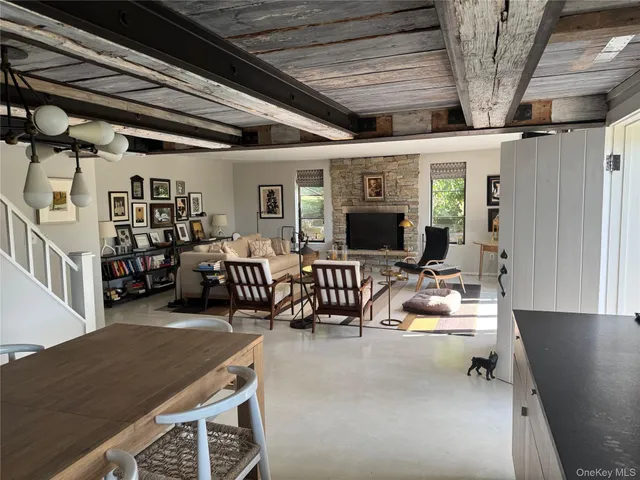 a living room with furniture a flat screen tv and a floor to ceiling window