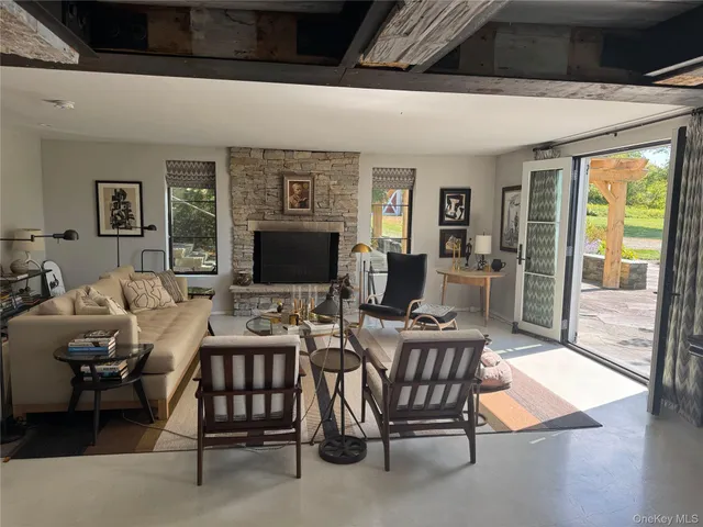 a living room with furniture and large windows